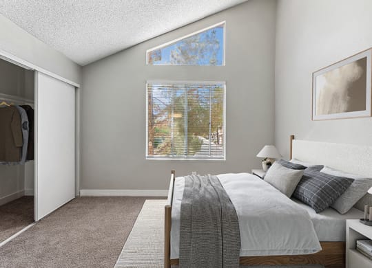 Model Bedroom with Carpet and Closet at Meadow Ridge Apartments in Las Vegas, NV.