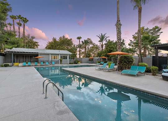 Community Swimming Pool with Pool Furniture at Lakeside Casitas Apartments located in Tucson, AZ.