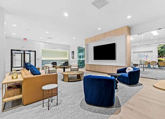 A modern lounge area with blue and beige furniture.