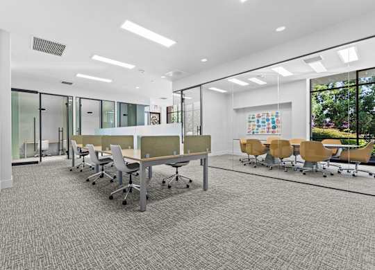 A conference room with a long table and chairs.