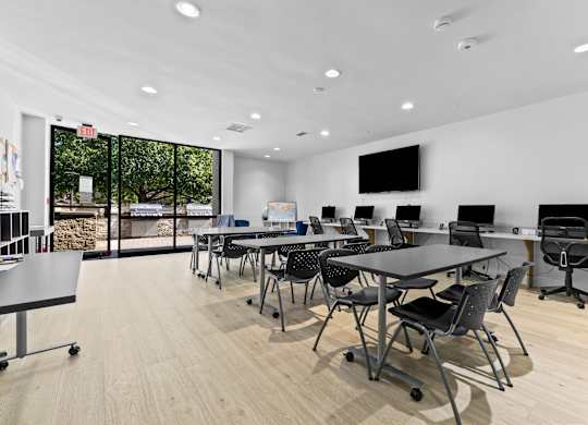 A conference room with a long table and chairs.