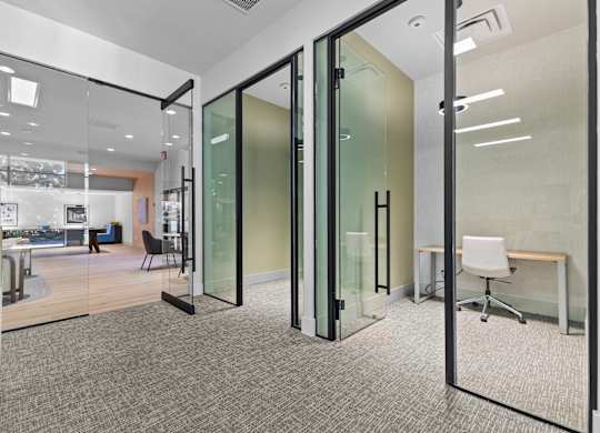A glass wall separates two rooms.