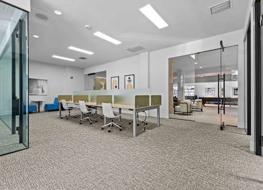 A conference room with a table and chairs.