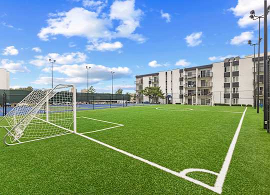 A soccer field with a goal in the middle of it.