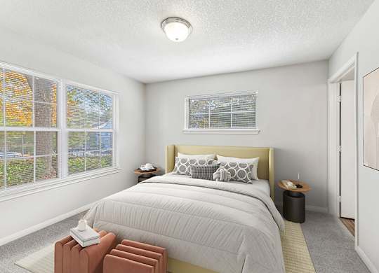 Model Bedroom with Carpet and Window View at Lake Cameron Apartments located in Apex, NC.