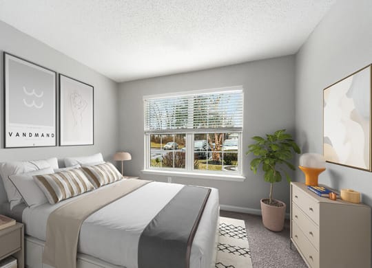 Model Bedroom with Carpet and Window View at Commons at Haynes Farm Apartments in Shrewsbury, MA.