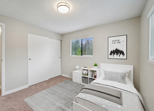 Model Bedroom with Carpet and Window View at Grammercy Apartments located in Renton, WA.