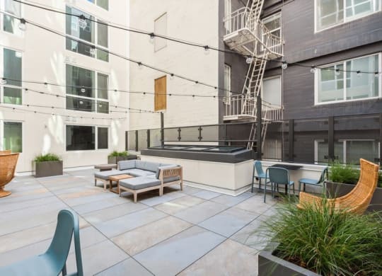 Outdoor lounge space with furniture at TL Residences