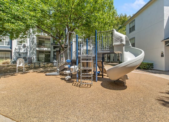 Community Playground with a Slide at Allure North Dallas Apartments in Dallas, TX.