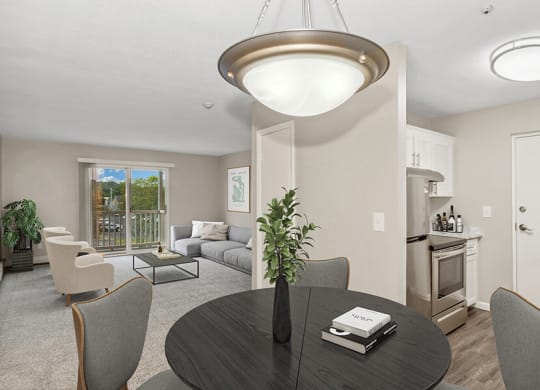 Model dining area with a table and chairs at Stone Ends apartments in Stoughton, MA