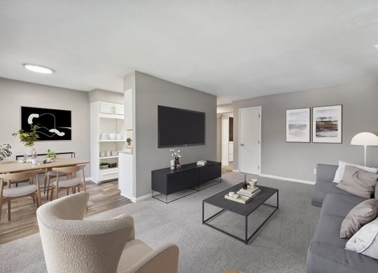 Model Living Room with Carpet and View of Kitchen/Dining Area at Spring Forest Apartments in Raleigh, NC.