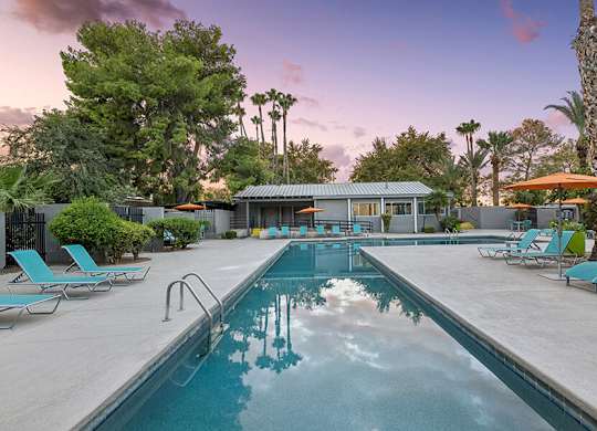 Community Swimming Pool with Pool Furniture at Lakeside Casitas Apartments located in Tucson, AZ.