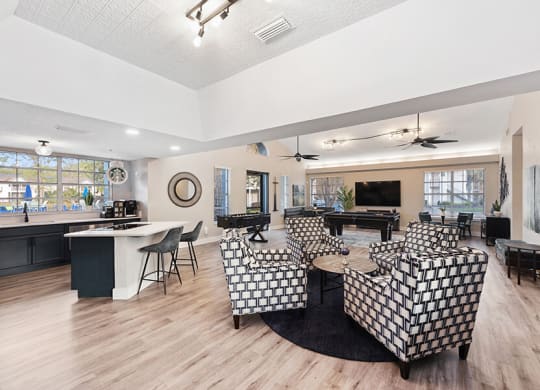 Community Clubhouse with Lounge Furniture and Kitchenette Area at Vue at Baymeadows Apartments in Jacksonville, FL.