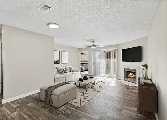 Model Living Room with Wood-Style Flooring, Fireplace and Patio Accessibility at Element 41 Apartments located in Marietta, GA.