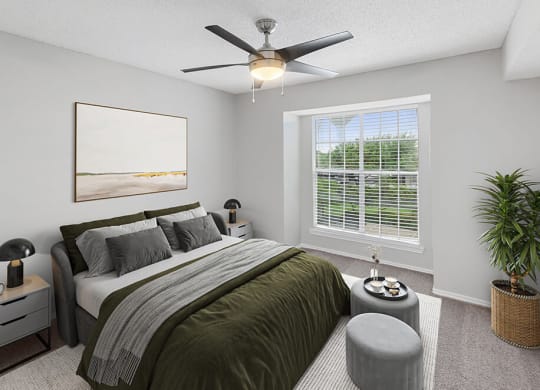 Model Bedroom with Carpet and Window View at Cobblestone Apartments in Arlington, TX.