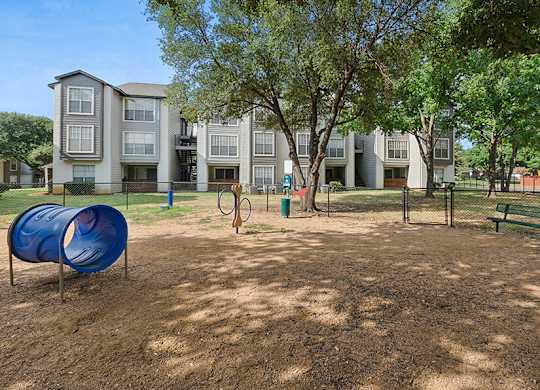 Community Dog Park with Agility Equipment at Cobblestone Apartments located in Arlington, TX.