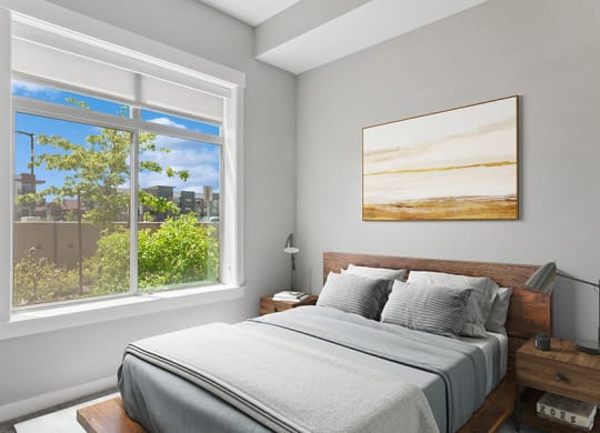 Model Bedroom with Carpet and Window View at Seven Skies Apartments located in Sandy, UT.