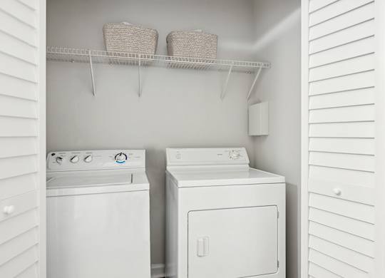 Model Laundry Room with Washer & Dryer at Dulles Green Apartments located in Herndon, VA.