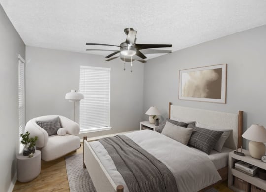 Model bedroom with a bed and a ceiling fan