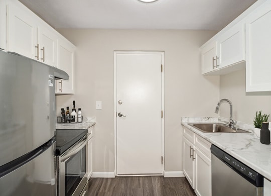 Mode kitchen with white cabinets and stainless steel appliances  at Stone Ends apartments in Stoughton, MA