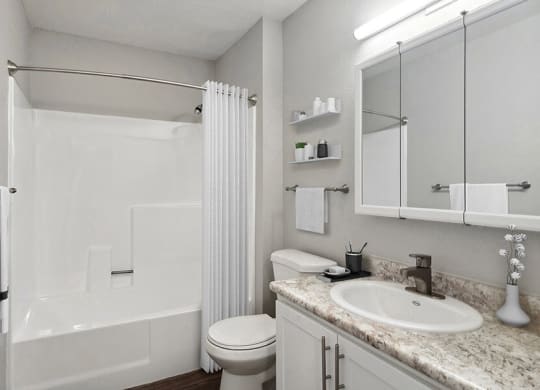 Model Bathroom with White Cabinets, Wood-Style Flooring and Shower/Tub at Overlook Point Apartments in Salt Lake City, UT.