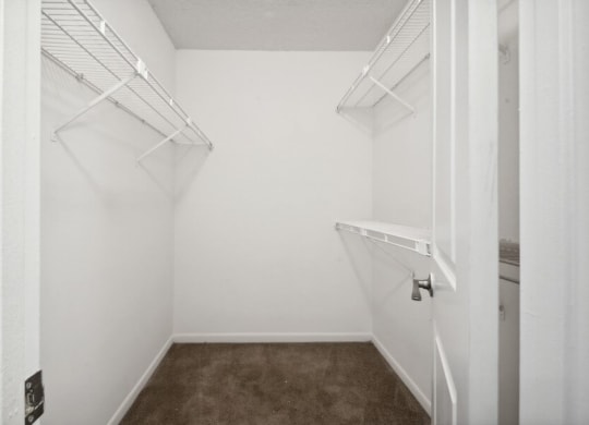 Model primary bedroom walk-in closet