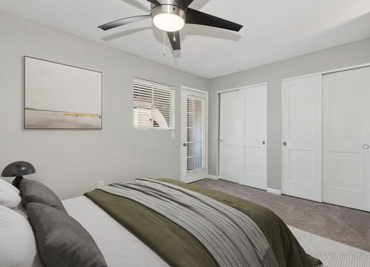 Model Bedroom with Carpet and Double Closets at Stillwater Apartments in Glendale, AZ.
