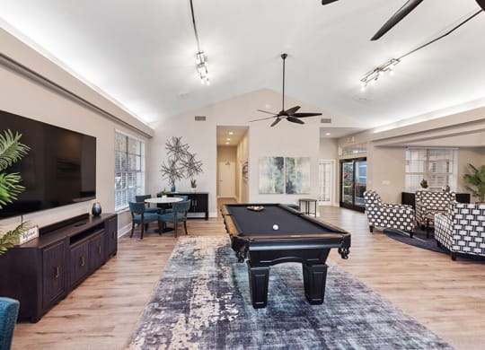 Community Clubhouse with Lounge Furniture and Pool Table Area at Vue at Baymeadows Apartments in Jacksonville, FL.