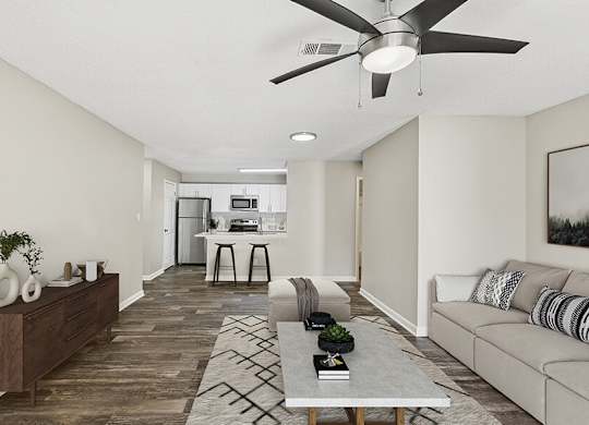 Model Living Room with Wood-Style Flooring and View of Kitchen at Element 41 Apartments located in Marietta, GA.