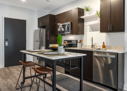 Model kitchen with an island and stainless steel appliances
