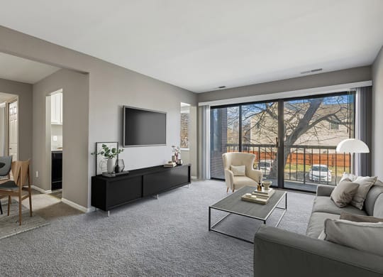 Model Living Room with Carpet and Patio Accessibility at Spring Parc Apartments in Silver Spring, MD.