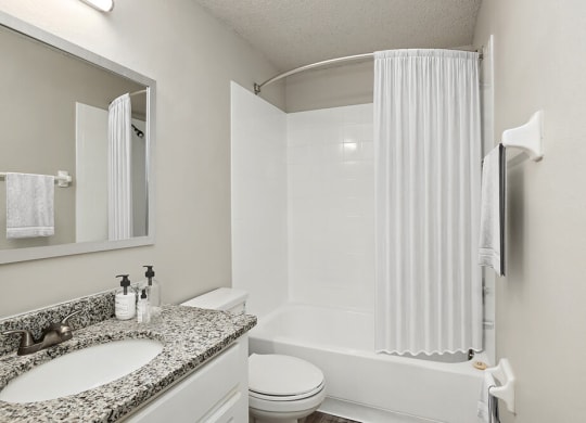 Model bathroom with a sink toilet and bathtub