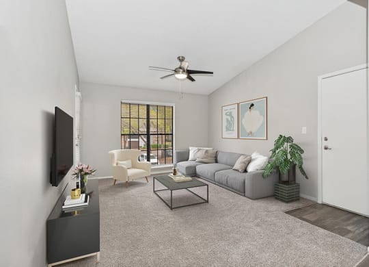 Model Living Room with Carpet and Window View at Grand Pavilion Apartments in Tampa, FL.