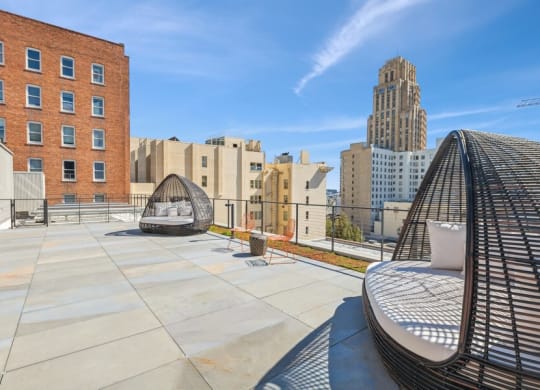 Rooftop lounge space with large pod chairs at TL Residences