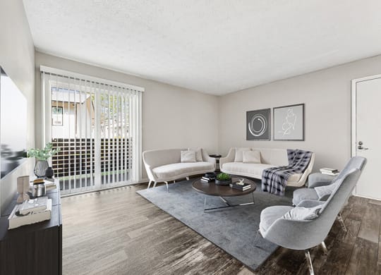Model Living Room with Wood-Style Flooring and Patio Accessibility at Paramont Apartments in Duluth, GA.