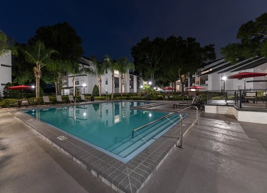 Community Swimming Pool with Pool Furniture at Rosehill Preserve Apartments located in Orlando, FL.