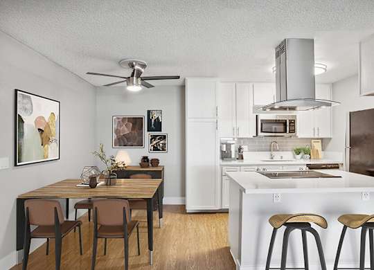 Model Kitchen with White Cabinets and Wood-Style Flooring at Cove La Mesa Apartments located in La Mesa, CA.