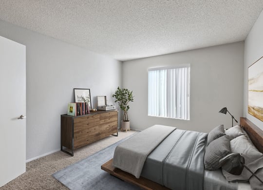 Model Bedroom with Carpet and Window View at Bridges on Sunset Apartments in Suisun City, CA.
