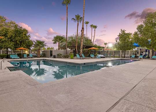 Community Swimming Pool with Pool Furniture at Lakeside Casitas Apartments located in Tucson, AZ.