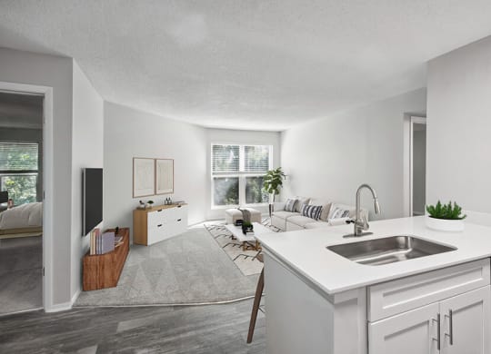 Model Kitchen with White Cabinets and View of Living Room at Arbor Village Apartments located in Charlotte, NC.