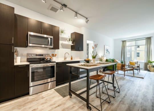 Model kitchen with stainless steel appliances and a table