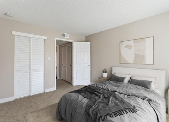 Model bedroom with a bed and a closet