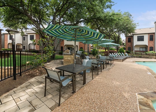 Community Swimming Pool and Grill Area at Dallas North Park Apartments in Dallas, TX.
