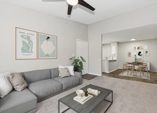 Model Living Room with Carpet and View of Kitchen/Dining Area at Grand Pavilion Apartments in Tampa, FL.