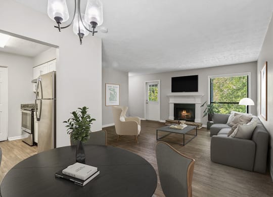 Model Dining Room with Wood-Style Flooring and View of Living Room at Lakeside Retreat Apartments located in Peachtree Corners, GA.