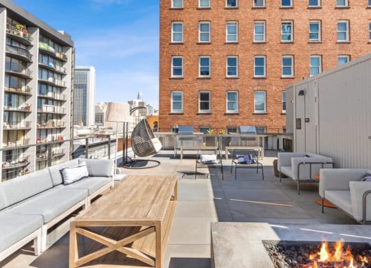 Rooftop lounge space with fire pit at TL Residences