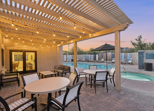 Community Patio Area with Lounge Furniture and View of Hot Tub at Ridgeline Apartments in Tucson, AZ.
