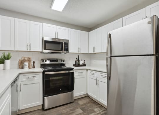 Model kitchen with stainless steel appliances at Retreat at Stonecrest Apartments