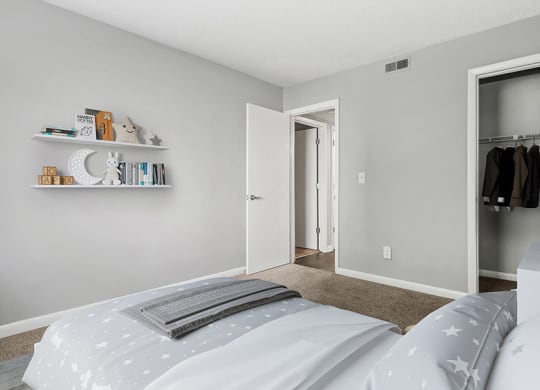 Model Bedroom with Carpet and Closet at Stoney Trace Apartments in Charlotte, NC.
