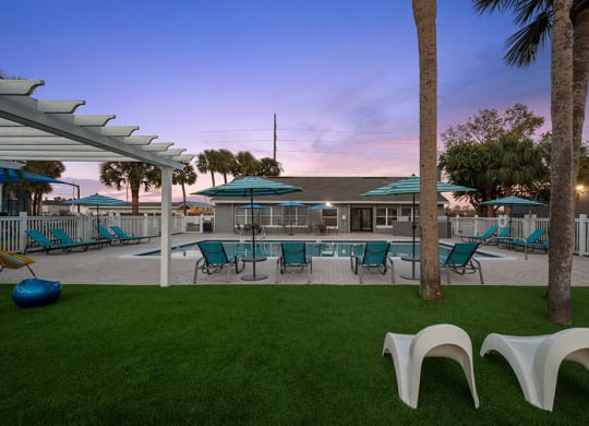 Community Swimming Pool with Pool Furniture at Park at 7200 Apartments in Jacksonville, FL.